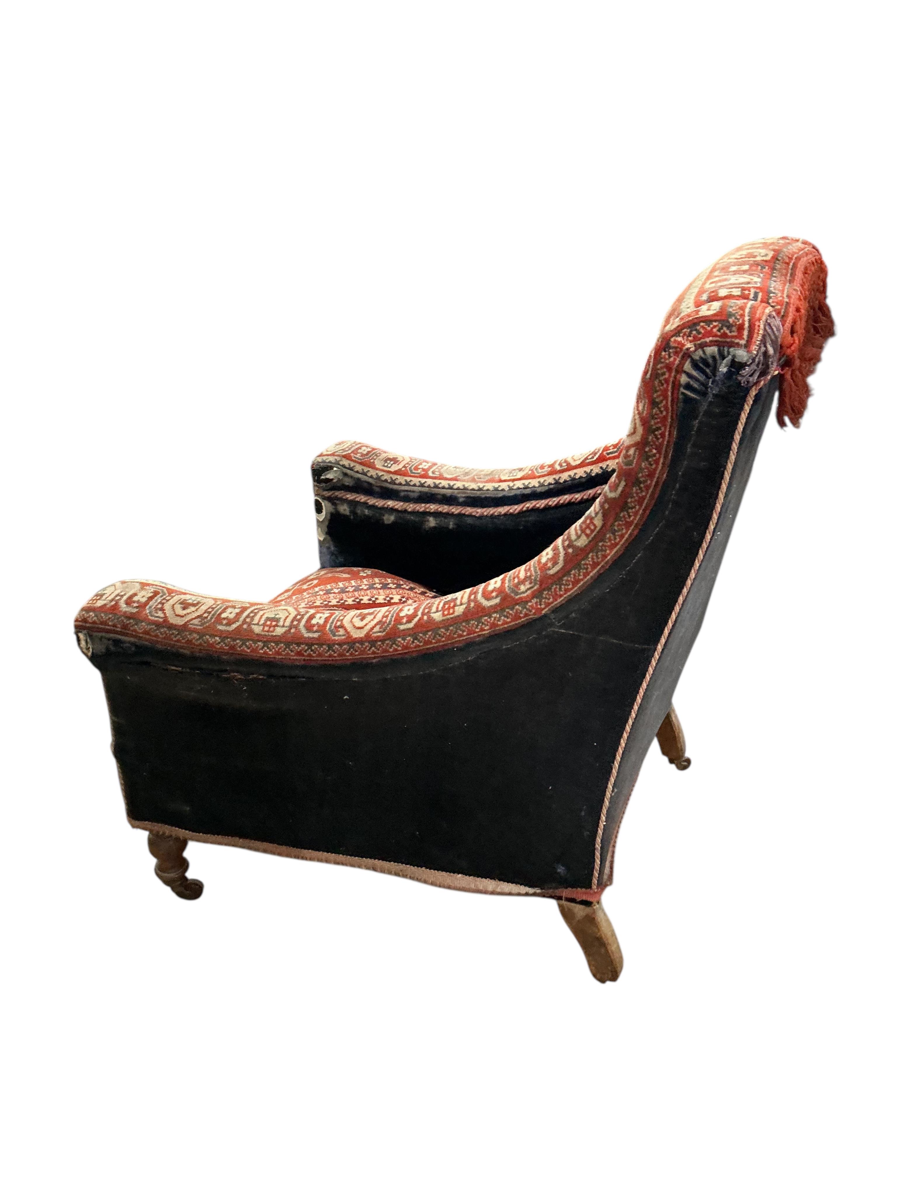 A Victorian carpet upholstered armchair, width 76cm, depth 78cm, height 90cm, Provenance: The late Kenneth Turner (1936-2025), celebrity florist, designer and perfume retailer, he received the Royal Warrant from the Prin